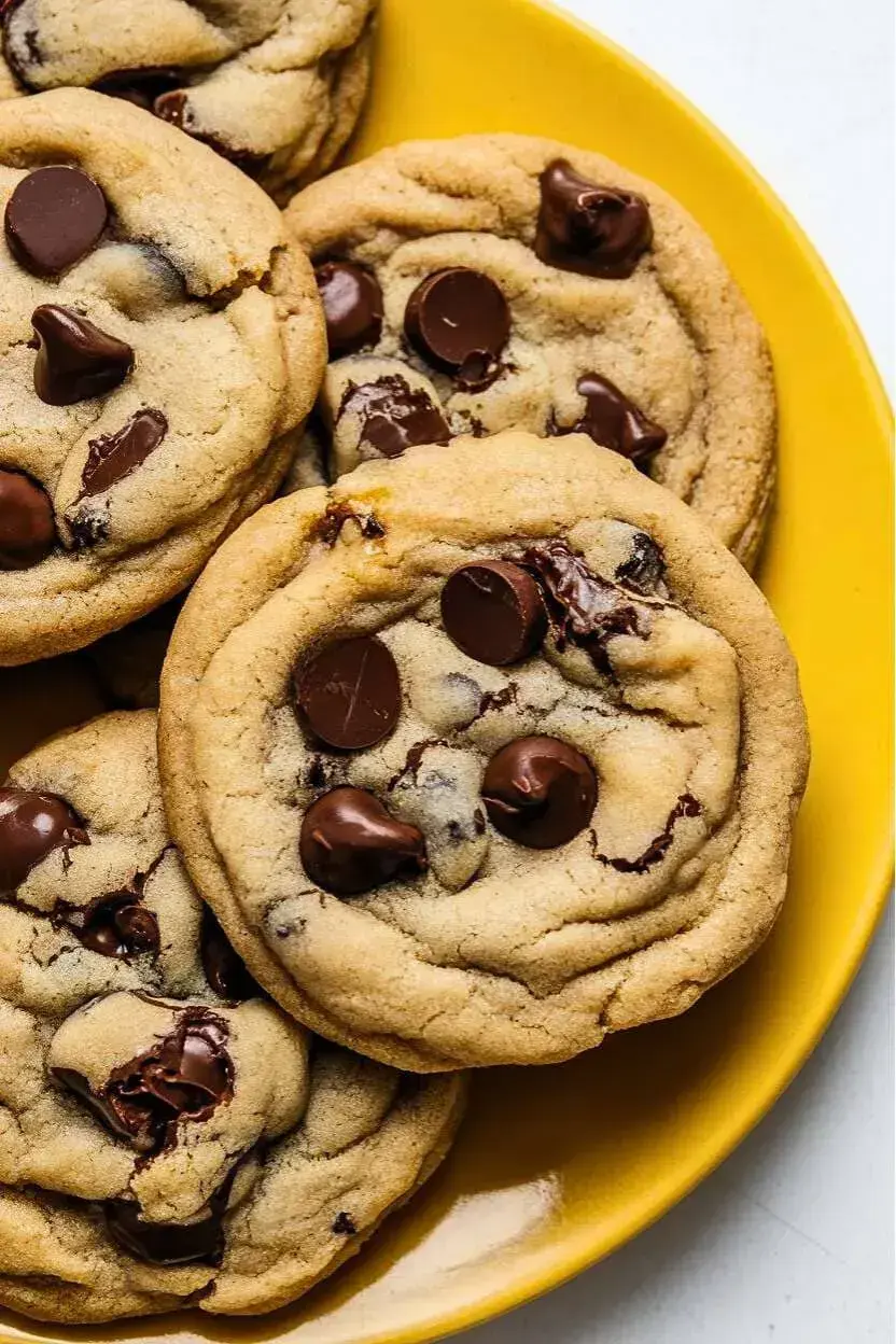 Top-down view of small batch chocolate chip cookies on a yellow plate