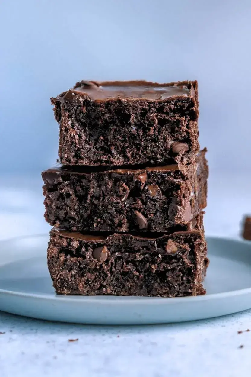 stack of banana brownies sits on a light blue plate.