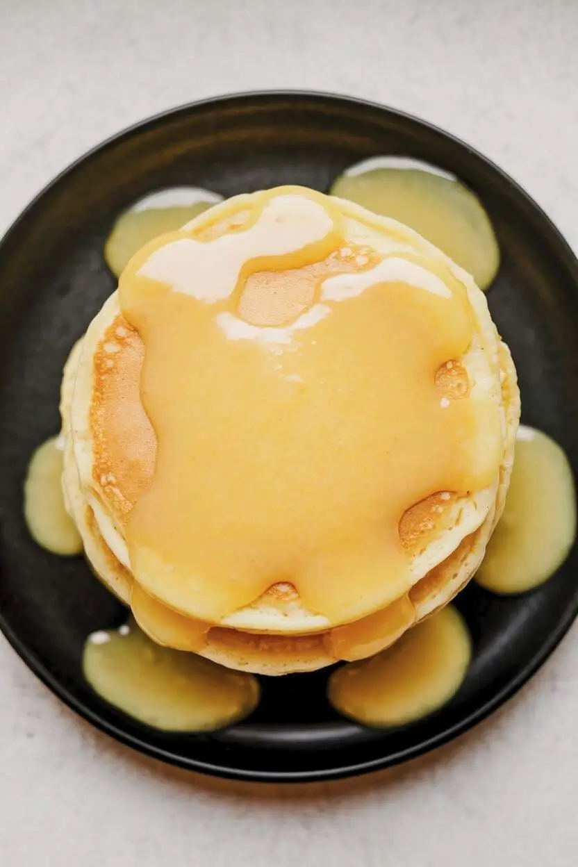 Top-down view of pancakes with lemon compote over the top.